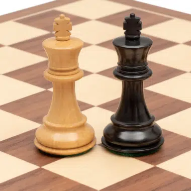 Rois blanc et noir en bois de buis face à face sur l'échiquier noyer et érable