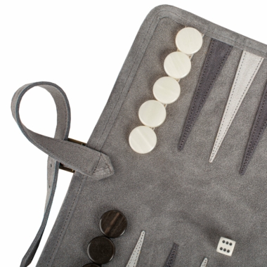 Détail du backgammon en daim vert forêt avec pions en position stratégique