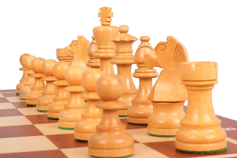 Plan rapproché des pièces blanches classiquement stylisées, évoquant l'excellence du jeu d'Échecs